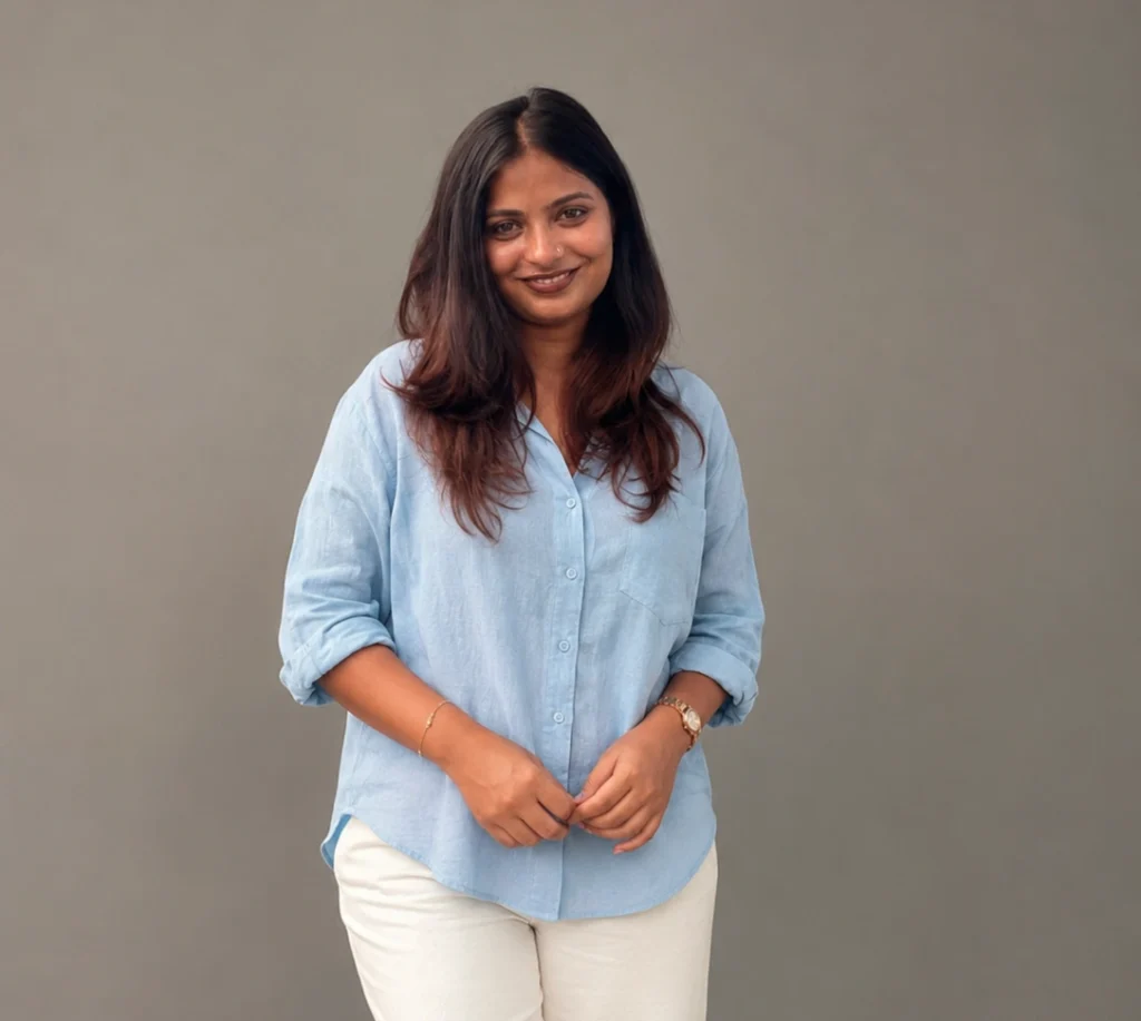 Freelance digital marketing strategist in Ernakulam smiling in a professional portrait against a grey background.